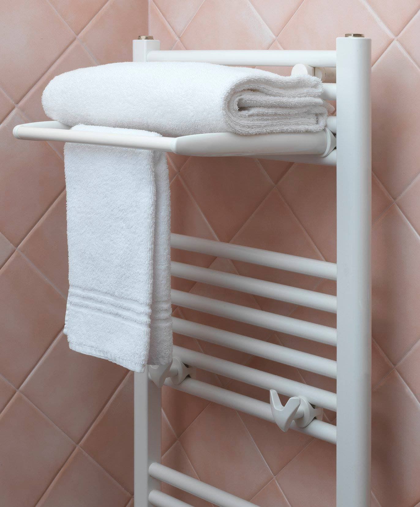 A heated towel rail with hanging bath towels in a bathroom